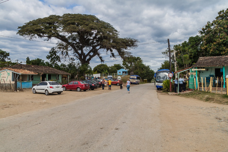 IZNAGA, CUBA - FEB 9, 2016: Tourist cars and buses in Iznaga village in Valle de los Ingenios valley near Trinidad, Cubaのeditorial素材