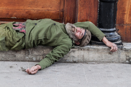 HAVANA, CUBA - FEB 22, 2016: Homeless man sleeping on the street in Old Havana.のeditorial素材