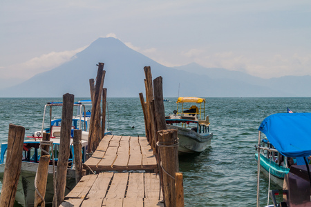 Wooden pier in Panajachel village, Guatemala. San Pedro volcano visible.の写真素材