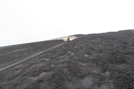 CERRO NEGRO, NICARAGUA - APRIL 26, 2016: Tourist is volcano boarding from Cerro Negro volcano, Nicaraguaのeditorial素材