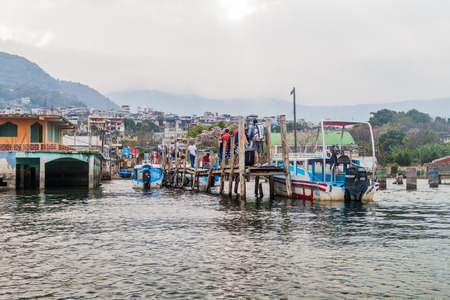 SAN PEDRO LA LAGUNA, GUATEMALA - MARCH 23, 2016: People on a wooden pier in San Pedro La Laguna village.のeditorial素材