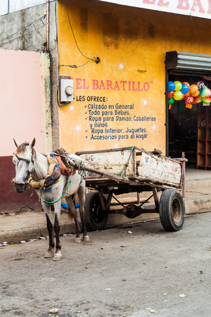 LEON, NICARAGUA - APRIL 27, 2016: Horse carriage parked in front of a store in Leon, Nicaraguaのeditorial素材