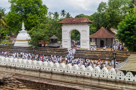 KANDY, SRI LANKA - JULY 19, 2016: White clothed Buddhist devotees at the grounds of the Temple of Sacred Tooth Relic during Poya (Full Moon) holiday.のeditorial素材