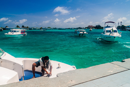 HULHULE ISLAND, MALDIVES - JULY 11, 2016: Boats at the harbor next to Ibrahim Nasir International Airport in Male, Maldives.のeditorial素材