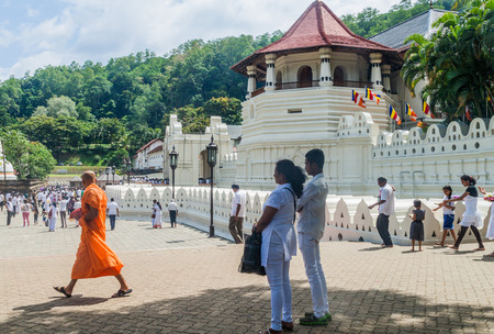 KANDY, SRI LANKA - JULY 19, 2016: White clothed Buddhist devotees visit Temple of the Sacred Tooth Relic during Poya (Full Moon) holiday.のeditorial素材