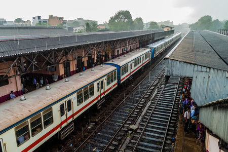 COLOMBO, SRI LANKA - JULY 12, 2016: Train in Maradana train station in Colombo during monsoon rain.