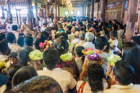 KANDY, SRI LANKA - JULY 19, 2016: White clothed Buddhist devotees in the Temple of Sacred Tooth Relic during Poya (Full Moon) holiday.のeditorial素材