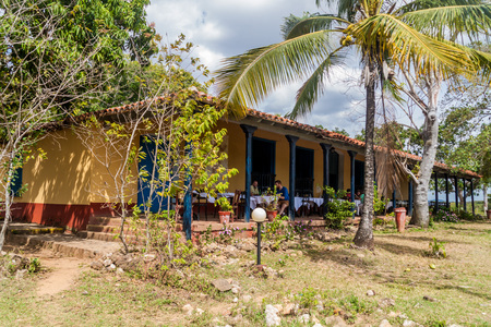 GUACHINANGO, CUBA - FEB 9, 2016: Tourists eat in an old  hacienda Casa Guachinango in Valle de los Ingenios valley near Trinidad, Cubaのeditorial素材