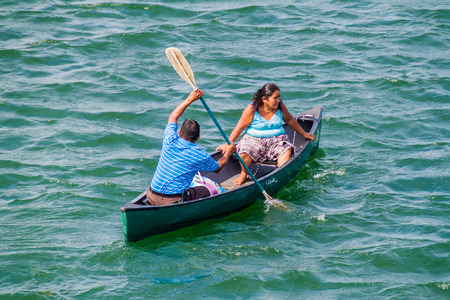 RIO DULCE, GUATEMALA - MARCH 10, 2016: Local indigenous people paddling across Rio Dulce river, Guatemalaのeditorial素材