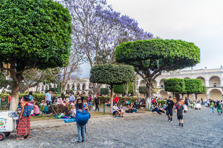 ANTIGUA, GUATEMALA - MARCH 25, 2016: Crowds of people on Plaza Mayor square in Antigua Guatemala town, Guatemala.のeditorial素材