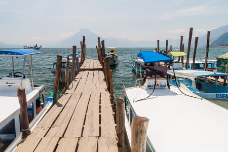 PANAJACHEL, GUATEMALA - MARCH 25, 2016:Wooden pier in Panajachel village, Guatemala. San Pedro volcano visible.のeditorial素材
