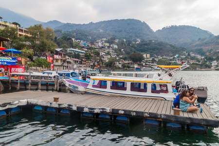 SANTIAGO ATITLAN, GUATEMALA - MARCH 24, 2016: Boats and wooden pier in Santiago Atitlan village.のeditorial素材