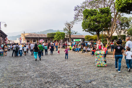 ANTIGUA, GUATEMALA - MARCH 25, 2016: Crowds of people on Plaza Mayor square in Antigua Guatemala town, Guatemala.のeditorial素材