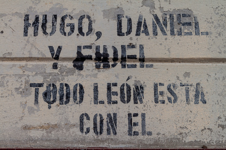 LEON, NICARAGUA - APRIL 25, 2016: Inscription on a wall of Revolution Museum in Leon, Nicaragua. It says: Hugo, Daniel and Fidel. Whole Leon is with him.のeditorial素材