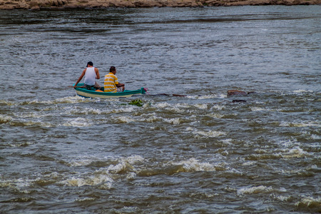 EL CASTILLO, NICARAGUA - MAY 6, 2016: Fishermen in a boat at the rapids of San Juan river near Ell Castillo village, Nicaraguaのeditorial素材
