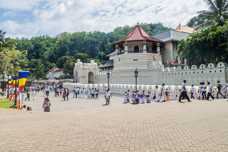 KANDY, SRI LANKA - JULY 19, 2016: White clothed Buddhist devotees visit Temple of the Sacred Tooth Relic during Poya (Full Moon) holiday.のeditorial素材