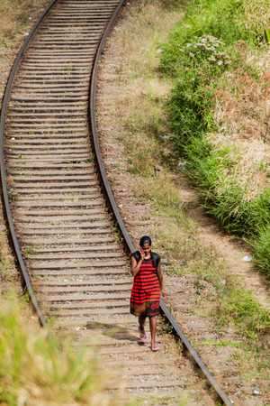 HAPUTALE, SRI LANKA - JULY 16, 2016: Local woman walks on railway tracks near Haputale.のeditorial素材