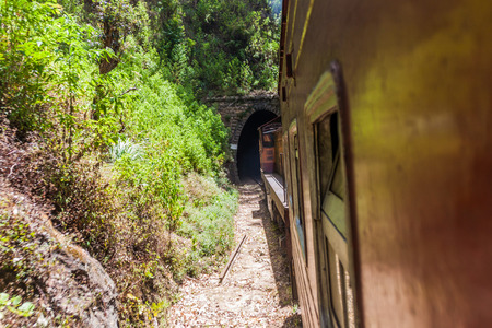 Train enters a tunnel near Idalgashinna, Sri Lankaの写真素材