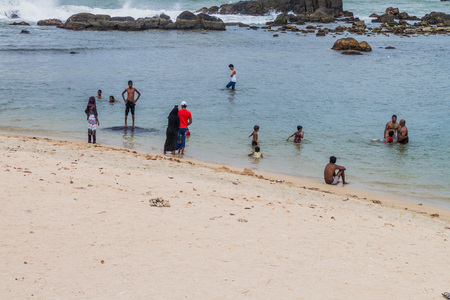 GALLE, SRI LANKA - JULY 12, 2016: People bathing at Lighthouse Beach in Galleのeditorial素材
