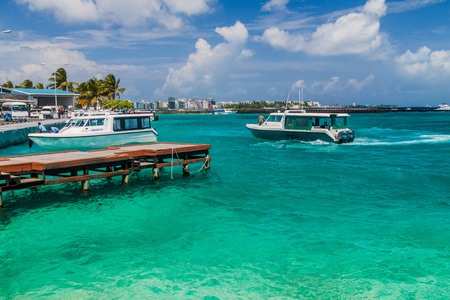 HULHULE ISLAND, MALDIVES - JULY 11, 2016: Boats at the harbor next to Ibrahim Nasir International Airport in Male, Maldives.のeditorial素材