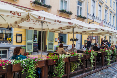 TALLINN, ESTONIA - AUGUST 22, 2016: People eat in a restaurant at Pikk street in the old town of Tallinn.のeditorial素材