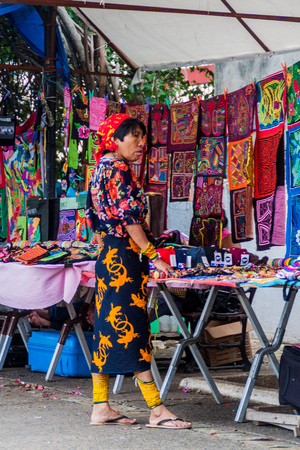 PANAMA CITY, PANAMA - MAY 27, 2016: Indigenous woman in the traditional dress sells souvenirs in Casco Viejo (Historic Center) of Panama Cityのeditorial素材