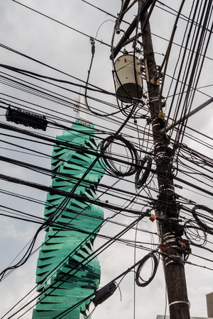 PANAMA CITY, PANAMA - MAY 30, 2016: F&F Tower skyscraper in Panama City viewed through a chaos of wiresのeditorial素材