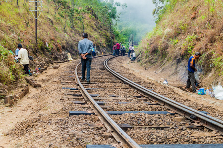 IDALGASHINNA, SRI LANKA - JULY 16, 2015: Workers maintain a railway track between Idalgashinna and Haputale.のeditorial素材