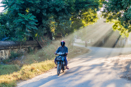 BAGAN, MYANMAR - DECEMBER 8, 2016: Motorcycle on a road in Nyaung U village in Bagan.のeditorial素材