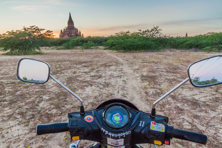 BAGAN, MYANMAR - DECEMBER 7, 2016: E-bike (electric scooter) on a dirt trail in Bagan, Myanmarのeditorial素材