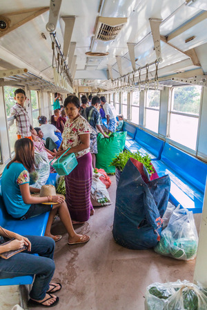 YANGON, MYANMAR - DECEMBER 16, 2016: Commuters in a carriage of a local train on Yangon circle line.のeditorial素材
