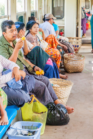 YANGON, MYANMAR - DECEMBER 16, 2016: Commuters in a carriage of a local train on Yangon circle line.のeditorial素材
