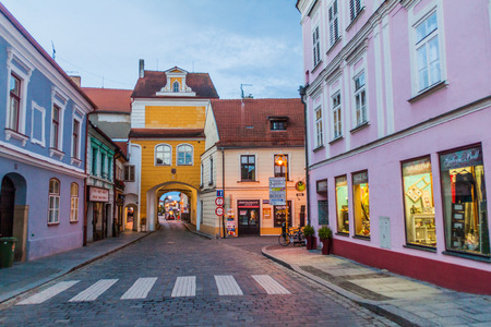 TREBON, CZECH REPUBLIC - JUNE 13, 2016: Cobbled street and Hradecka gate in the old town of Trebon, Czech Republic.のeditorial素材