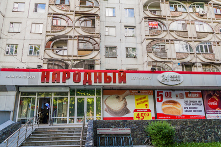 BISHKEK, KYRGYZSTAN - MAY 19, 2017: Concrete apartment building with Narodnyi supermarket in Bishkek, capital of Kyrgyzstan.のeditorial素材