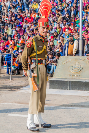 WAGAH, INDIA - JANUARY 26, 2017: Border guard watched by Indian spectators at the military ceremony at India-Pakistan border in Wagah in Punjab, India.のeditorial素材