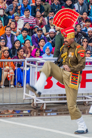 WAGAH, INDIA - JANUARY 26, 2017: Border guard watched by Indian spectators at the military ceremony at India-Pakistan border in Wagah in Punjab, India.のeditorial素材