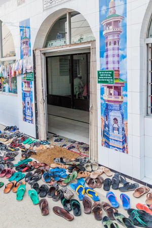 RAJSHAHI, BANGLADESH - NOVEMBER 9, 2016: Various shoes in front of a mosque in Rajshahi, Bangladeshのeditorial素材