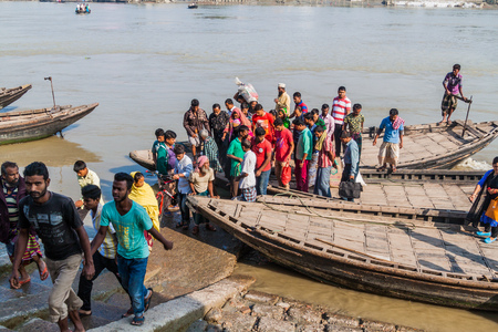 KHULNA, BANGLADESH - NOVEMBER 16, 2016: People leave a ferry on Rupsa river in Khulna, Bangladesh
