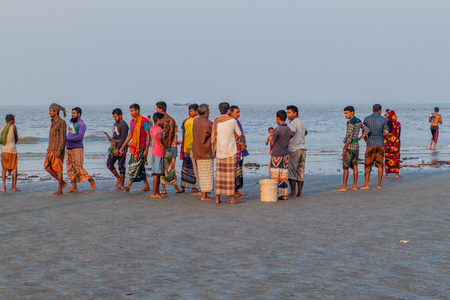 DUBLAR CHAR, BANGLADESH - NOVEMBER 14, 2016: People on a beach during Rash Mela festival at Dublar...