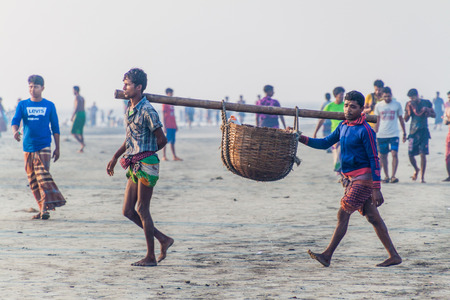 DUBLAR CHAR, BANGLADESH - NOVEMBER 14, 2016: Fishermen with their catch at Dublar Char (Dubla island), Bangladesh.のeditorial素材