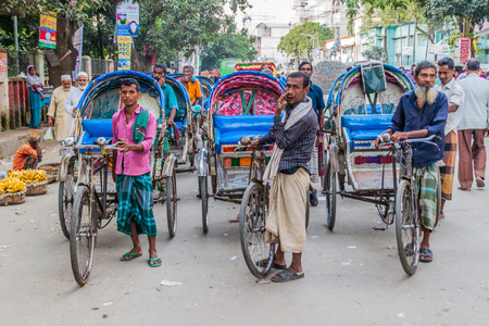 BOGRA, BANGLADESH - NOVEMBER 7, 2016: Rickshaw riders on a street in Bogra, Bangladesh.のeditorial素材