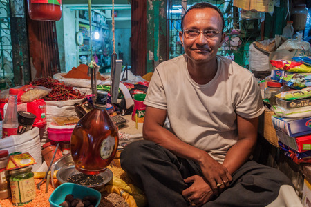 KHULNA, BANGLADESH - NOVEMBER 12, 2016: Local seller at a market in Khulna, Bangladeshのeditorial素材