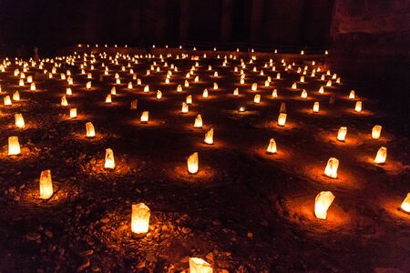 Candles glowing in front of the Al Khazneh temple (The Treasury) during Petra by Night in the ancient city Petra, Jordanの写真素材