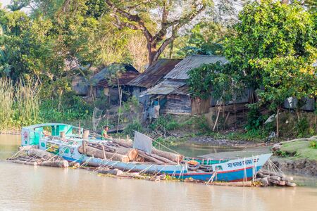GABKHAN CHANNEL, BANGLADESH - NOVEMBER 19, 2016: Cargo ship loaded with logs on Gabkhan Channel, Bangladeshのeditorial素材