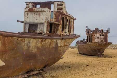 Rusty abandoned ships at the Ship cemetery at the former Aral sea coast in Moynaq (Moâ€˜ynoq or...