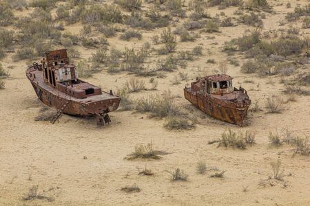 Rusty ships at the ship cemetery in former Aral sea  port town Moynaq (Moâ€˜ynoq or Muynak),...
