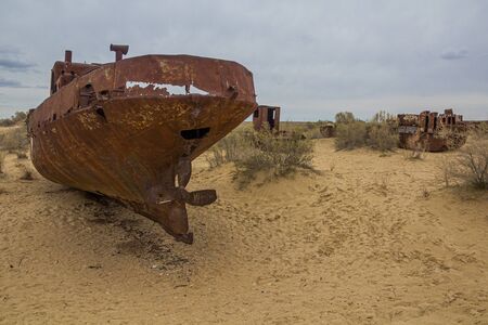 Rusty ships at the ship graveyard in former Aral sea port town Moynaq (Moâynoq or Muynak), Uzbekistanの写真素材
