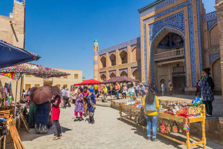 KHIVA, UZBEKISTAN - APRIL 26, 2018: Street market in front of Islam Khoja Madrasa in the old town of Khiva, Uzbekistan.のeditorial素材
