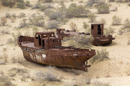 MUYNAQ, UZBEKISTAN - APRIL 22, 2018: Rusty ships at the ship cemetery in former Aral sea  port town Moynaq (Moâynoq or Muynak), Uzbekistanのeditorial素材