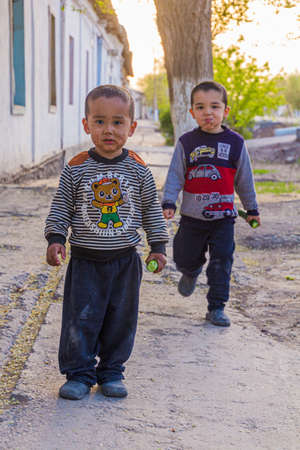KONYE-URGENCH, TURKMENISTAN - APRIL 20, 2018: Young boys on a street in Konye-Urgench, Turkmenistanのeditorial素材